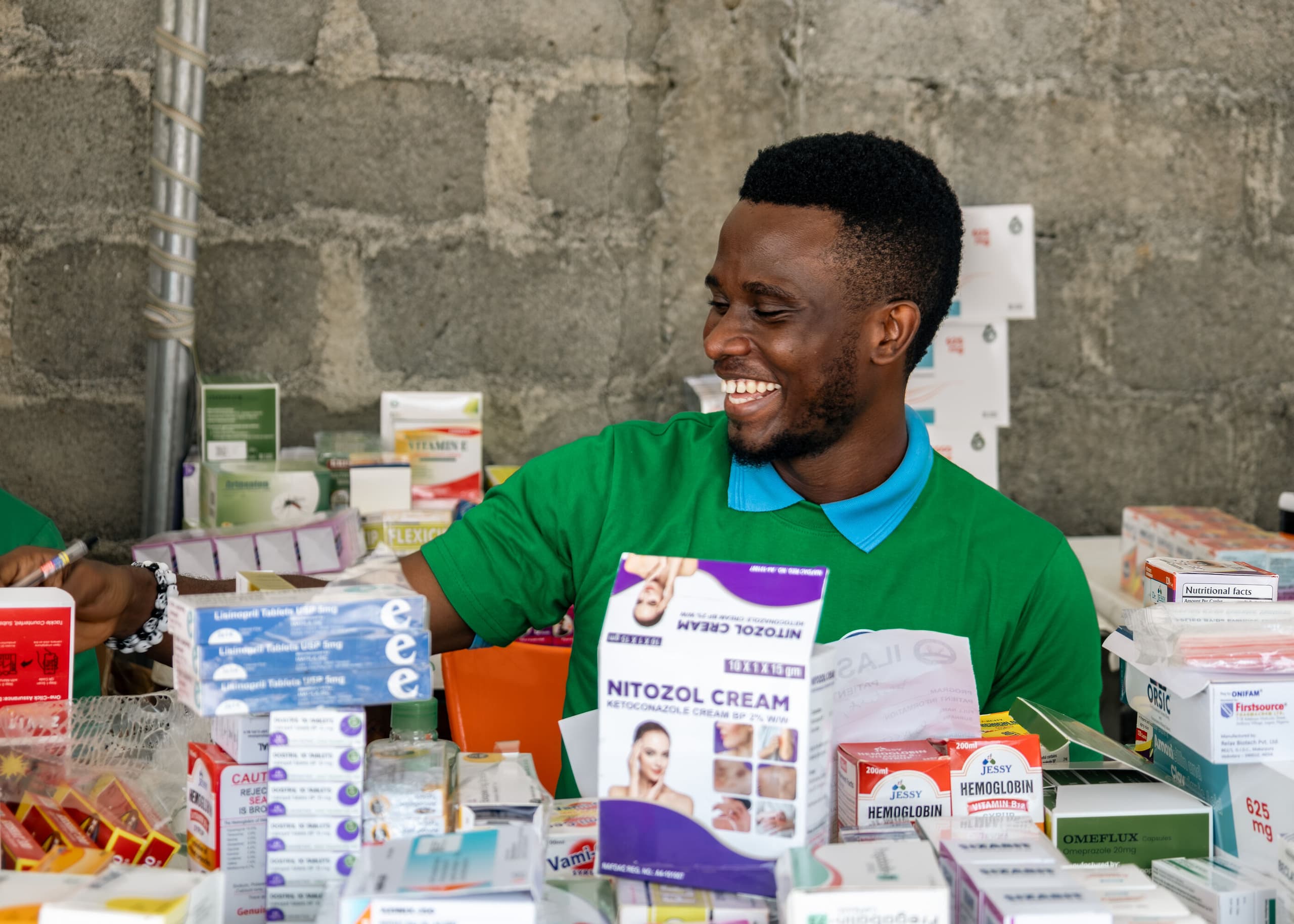 The dispensary table at the Ilasan outreach, stocked and staffed.